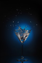 splashes of liquid in the martini glass with ice