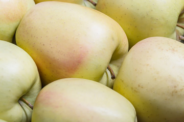 Raw delicious apples golden with skin background