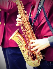 young player plays the saxophone