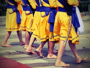 Five men of Sikh Religion with long dresses walking