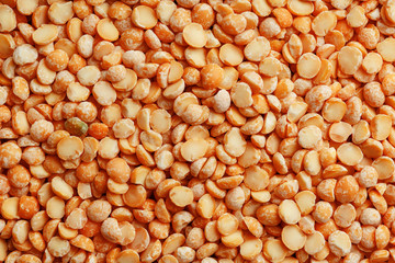 Background texture of pea porridge golden color in full-frame form. View from above. Close-up