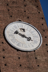Massive wall clock on a brick tower in Siena, Italy 