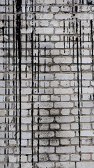 White brick background with black dripping paint drops