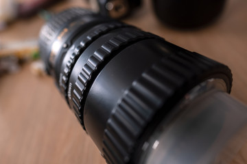 Fototapeta na wymiar digital camera lens in hand macro extension tubes metal form shape way perspective focus defocus, grip button exposure reach insect study session photoshoot