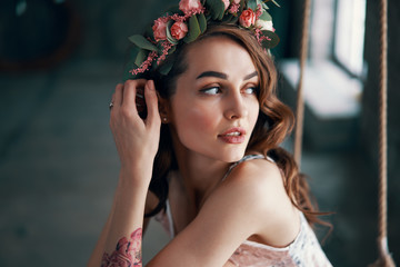 Sensual beautiful woman portrait with wreath of flowers in her hair