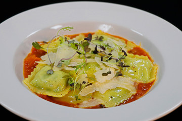 spinach and ricota cheese ravioli with saffron tomato sauce