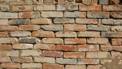 Brick wall close-up. Brick laying on cement mortar.