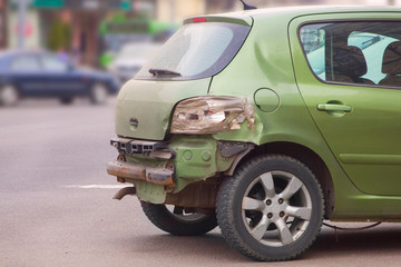 Fototapeta na wymiar green car after an accident