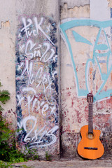 wall with graffiti and guitar on the floor