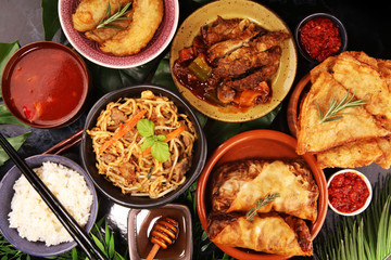 Assorted Chinese food set. Chinese noodles, fried rice, peking duck, dim sum, spring rolls. Famous Chinese cuisine dishes on table. Chinese restaurant