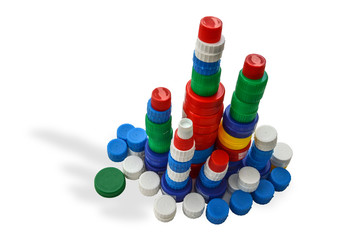 Tower of colorful plastic bottle caps isolated on white