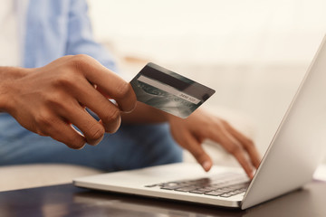 Man purchasing product online, using credit card to pay