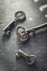Shallow DOF. Set of vintage worn out keys on a wooden background.