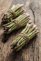 Fresh green asparagus on old oak table