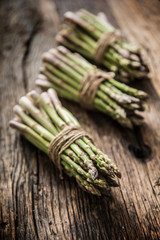 Fresh green asparagus on old oak table