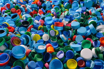 Sorting impressive number of colorful bottle plastic caps spread and ready to be recycled. Close-up of stack .