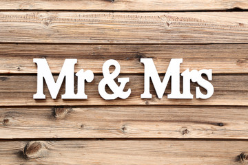 White letters Mr and Mrs on brown wooden table