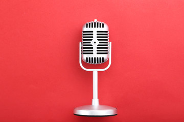 Vintage microphone on red background