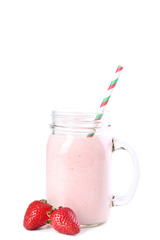 Strawberry smoothie in glass jar with straw on white background