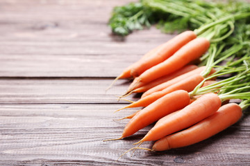 Fresh and sweet carrot on wooden background