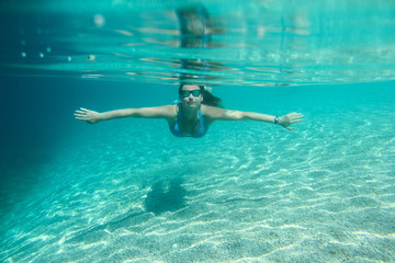 Fototapeta na wymiar Woman diving swimming underwater view