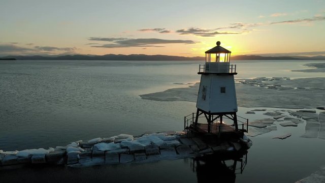 Drone ascends above the icy lake in Burlington, Vermont