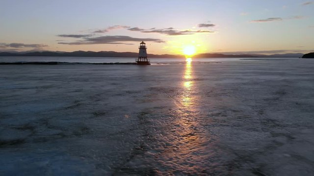 Flying past the lighthouse at sunset in Burlington, Vermont.
