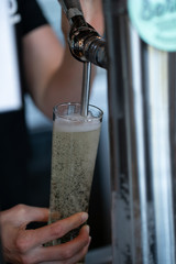 pulling a glass of cider