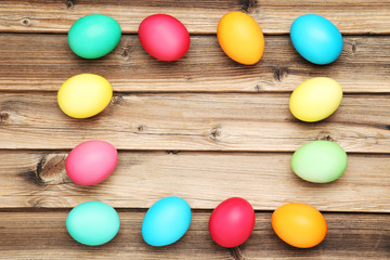 Colorful easter eggs on brown wooden table