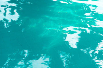 Fototapeta na wymiar Ripple Water in swimming pool with sun reflection