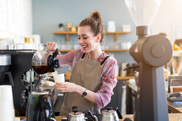Female barista making coffee 