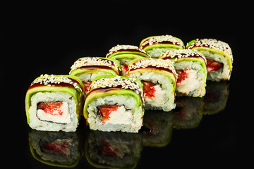 Philadelphia roll sushi with salmon, avocado, cream cheese on black background for menu. Japanese food