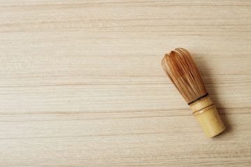 Bamboo tea whisk for matcha on wooden table