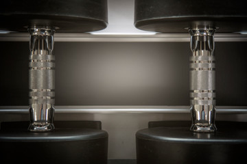 background of black dumbbells on rack for training equipment in fitness