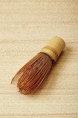 Bamboo tea whisk for matcha on wooden table