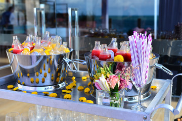 drinks cart with ice buckets and juice bottles, beverage cart, beverage display, social party, drinks cart, steering wheel bar, steering wheel drink, social event