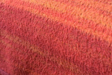 a woolen blanket with a red and orange pattern