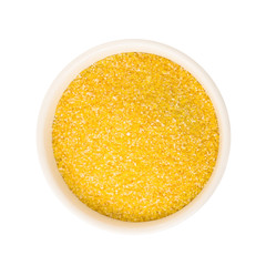 Top view of corn or maize grits in round ceramic plate. Raw food ingredient isolated on white background