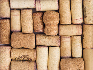 Top view of wine and champagne corks with red stains. Vintage background