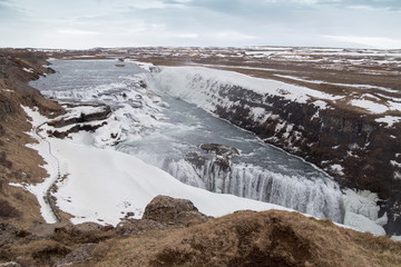 Amazing Icelandic winter landscape of majestic waterfall of frozen Gullfoss