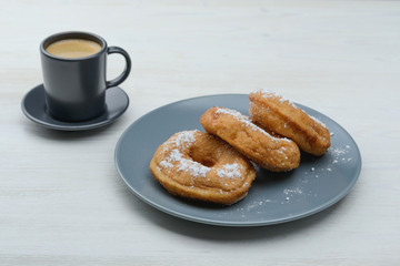 sweet donuts on a plate and espresso