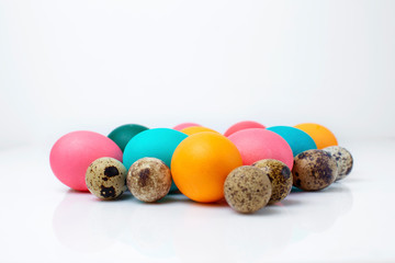 pyramid painted easter chicken and quail eggs in a pile on a white background. Happy Easter. Easter set. isolated in white
