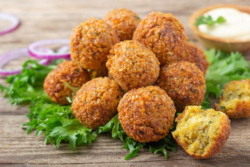Vegetarian dish - falafel balls from spiced chickpeas on wooden rustic table.