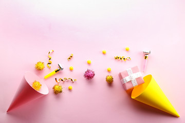 Birthday party traditional accessories and celebration attributes on bright paper textured background. Close up, top view, copy space, flat lay.