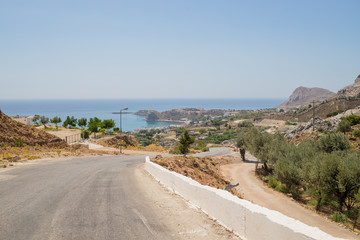 Road and Natural Landscape.Empty mountain asphalt road in Corfu island, Greece. Wide angle lens shot.Empty asphalt road highway in the forested mountains.Carefree driving on a bright sunny day.