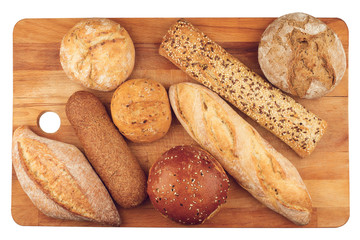 different types of bread on wooden kitchen cutting board