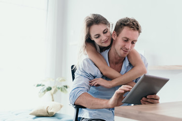 Couple love surfing with digital tablet on the internet in the morning