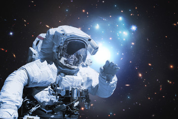 Obraz na płótnie Canvas astronaut walking in outer space, elements of this image furnished by nasa b