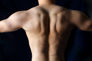 Fototapeta premium torso of brutal muscular fitness athlete of a sporty man against black background