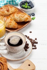 Coffee, juice and croissants breakfast
